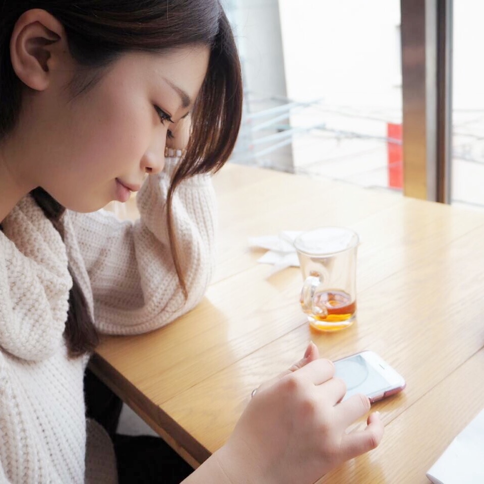 Haruka Shibata looks at phone on table